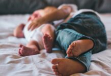 독박육아 걱정? 우리 마을 ‘공동육아’로 해소 노원구, 공동육아방 11개소 운영 a close up of a person laying on a bed