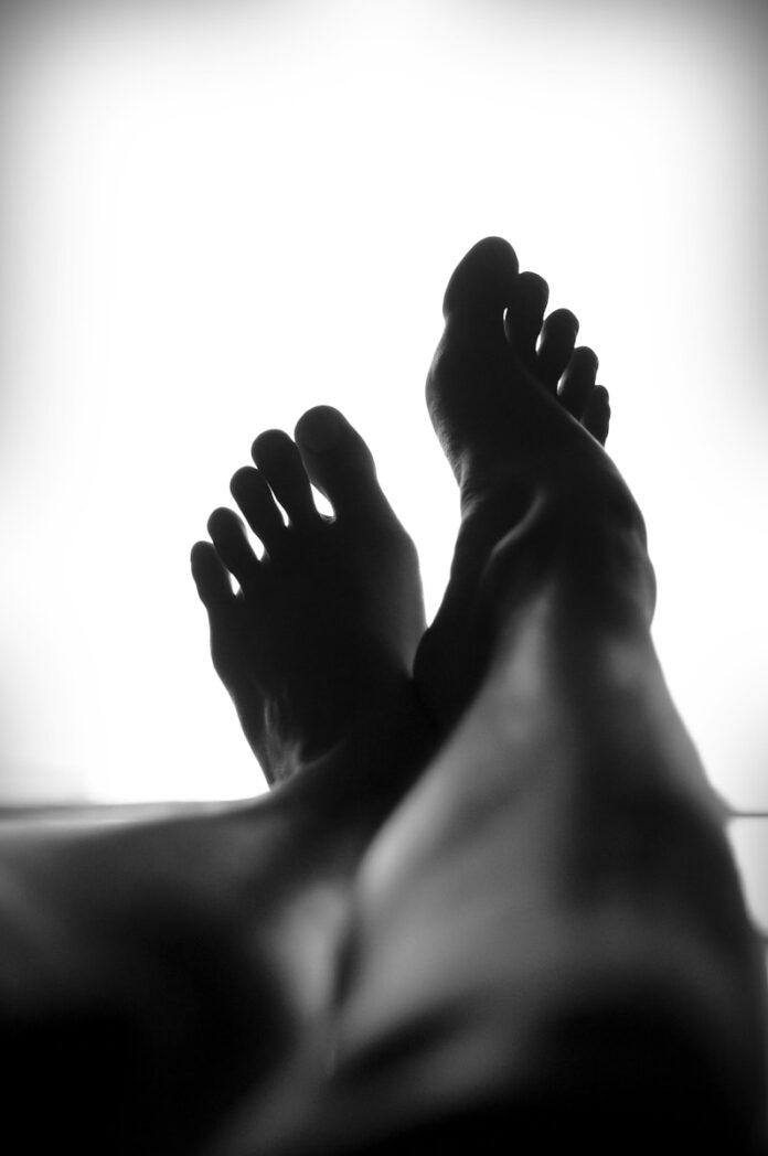 Photo by How-Soon Ngu silhouette of person's feet against white background