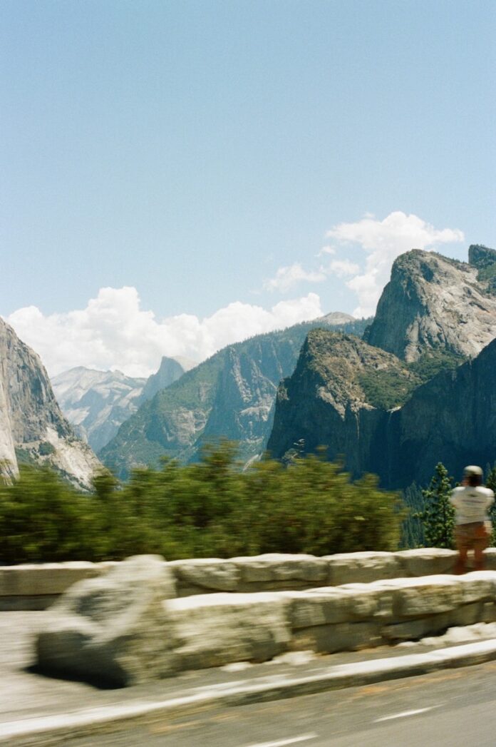 Man photographing granite cliffs in yosemite national park