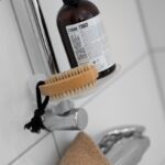 ‘두피 케어’가 대세…건강한 모발 위한 맞춤형 헤어 관리법 주목 A bottle of soap sitting on top of a faucet