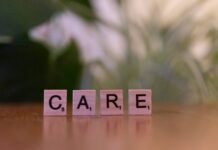 “일상 속 스트레스, 작지만 꾸준한 습관이 해답” A wooden block spelling care on a table
