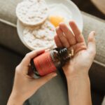 “내 몸에 맞는 영양, 똑똑하게 챙기는 실생활 보충제 활용법” person holding red bottle