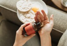 “내 몸에 맞는 영양, 똑똑하게 챙기는 실생활 보충제 활용법” person holding red bottle