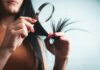 건강한 모발을 위한 똑똑한 헤어 관리, 일상 속 실천법은? Woman examining split ends of hair with magnifying glass