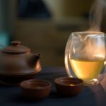 수면 최적화로 당신의 하루를 살리세요: 건강한 잠을 위한 실전 팁 a glass of white wine next to a tea pot